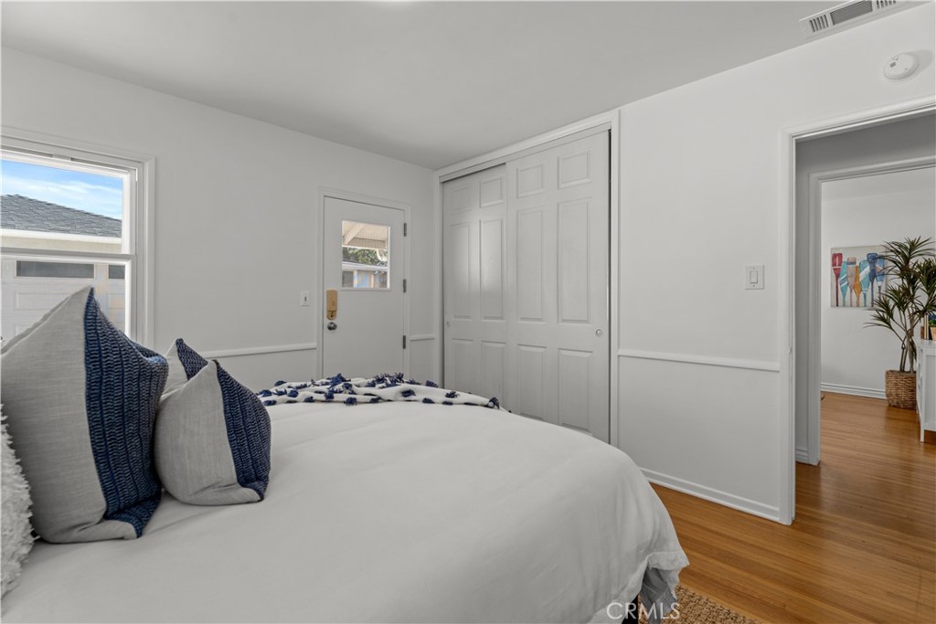 208 West Walnut Avenue El Segundo, CA 90245 - Photo 23 of 38 a bedroom with a bed and wooden floor