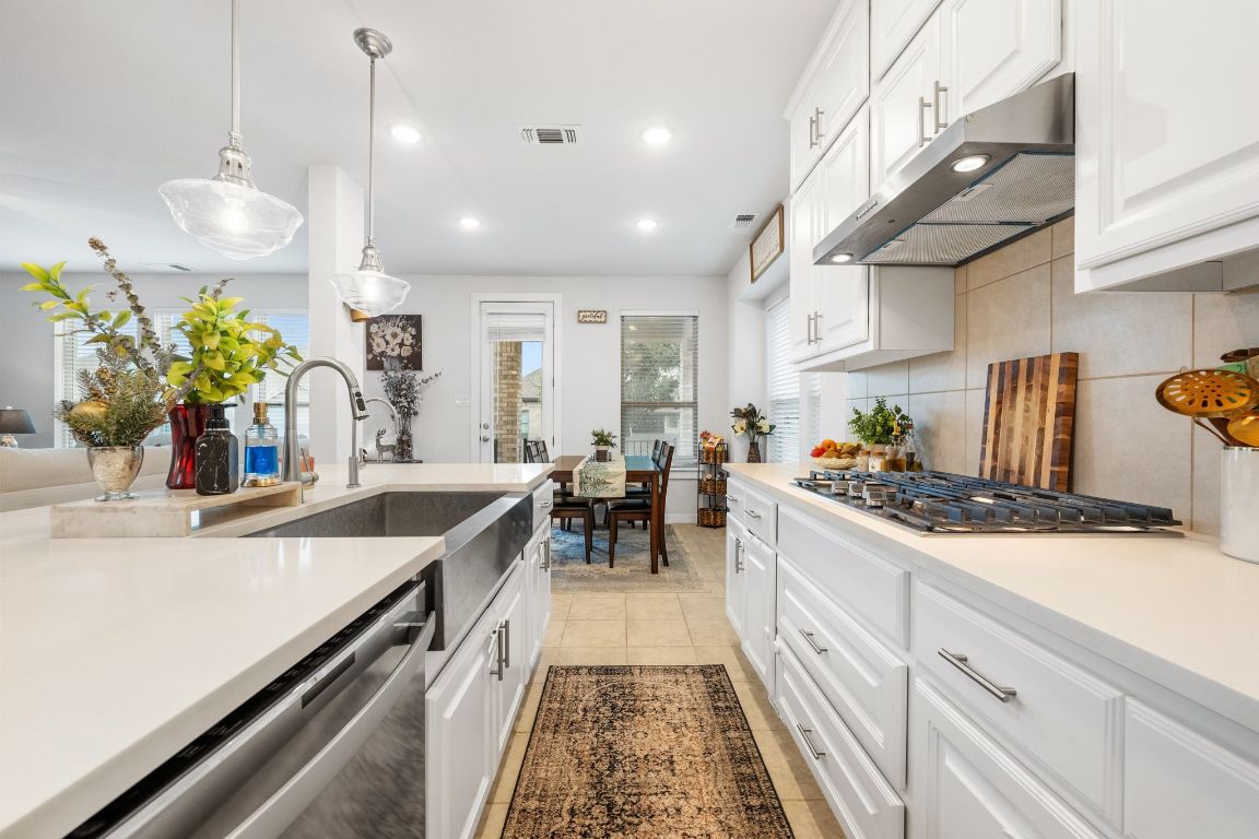 128 Three Oaks Lane Georgetown, TX 78628 - Photo 10 of 40 a kitchen with stove a sink and cabinets