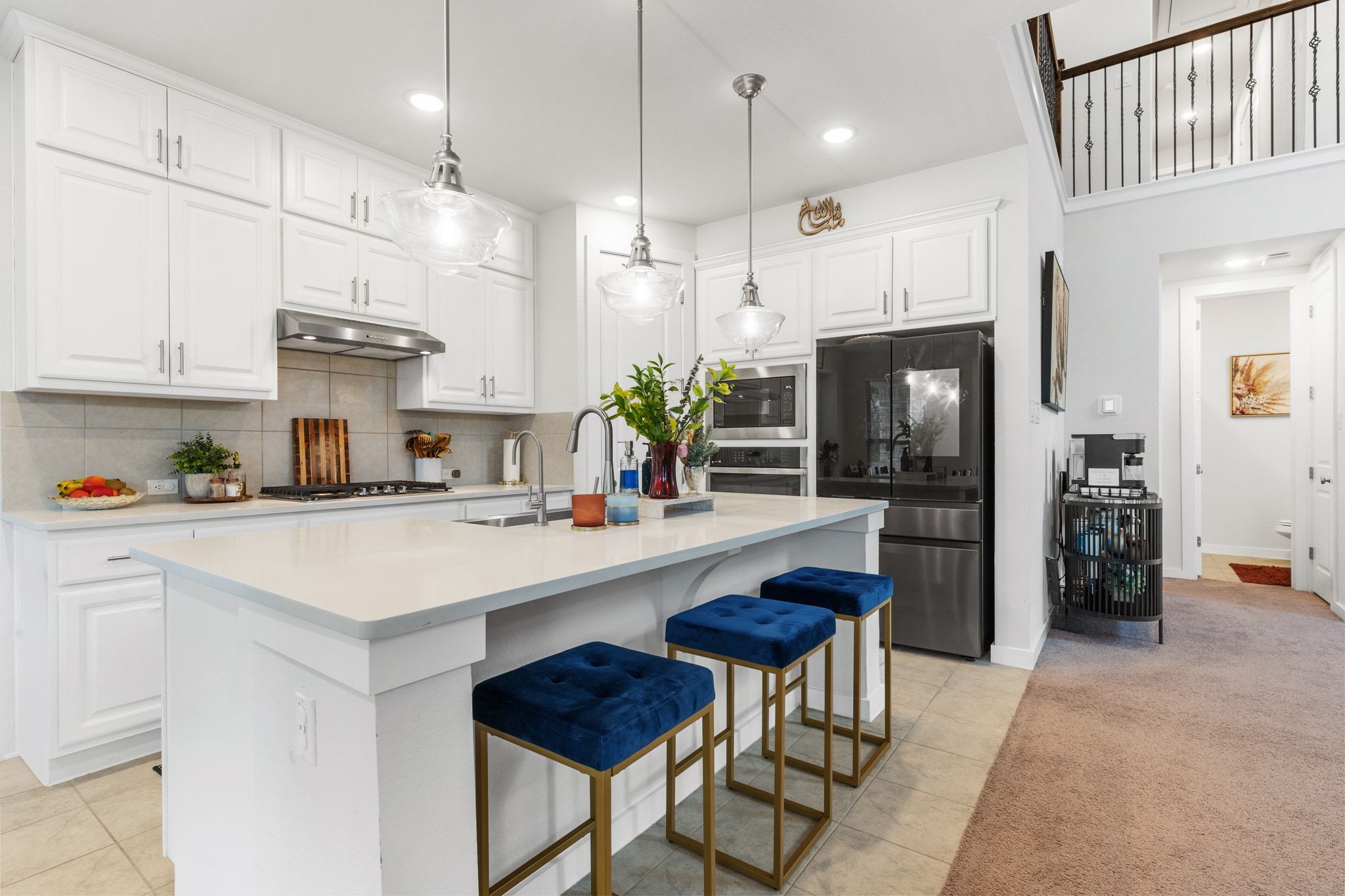 128 Three Oaks Lane Georgetown, TX 78628 - Photo 11 of 40 Kitchen with decorative backsplash, appliances with stainless steel finishes, white cabinets, a breakfast bar area, and decorative light fixtures