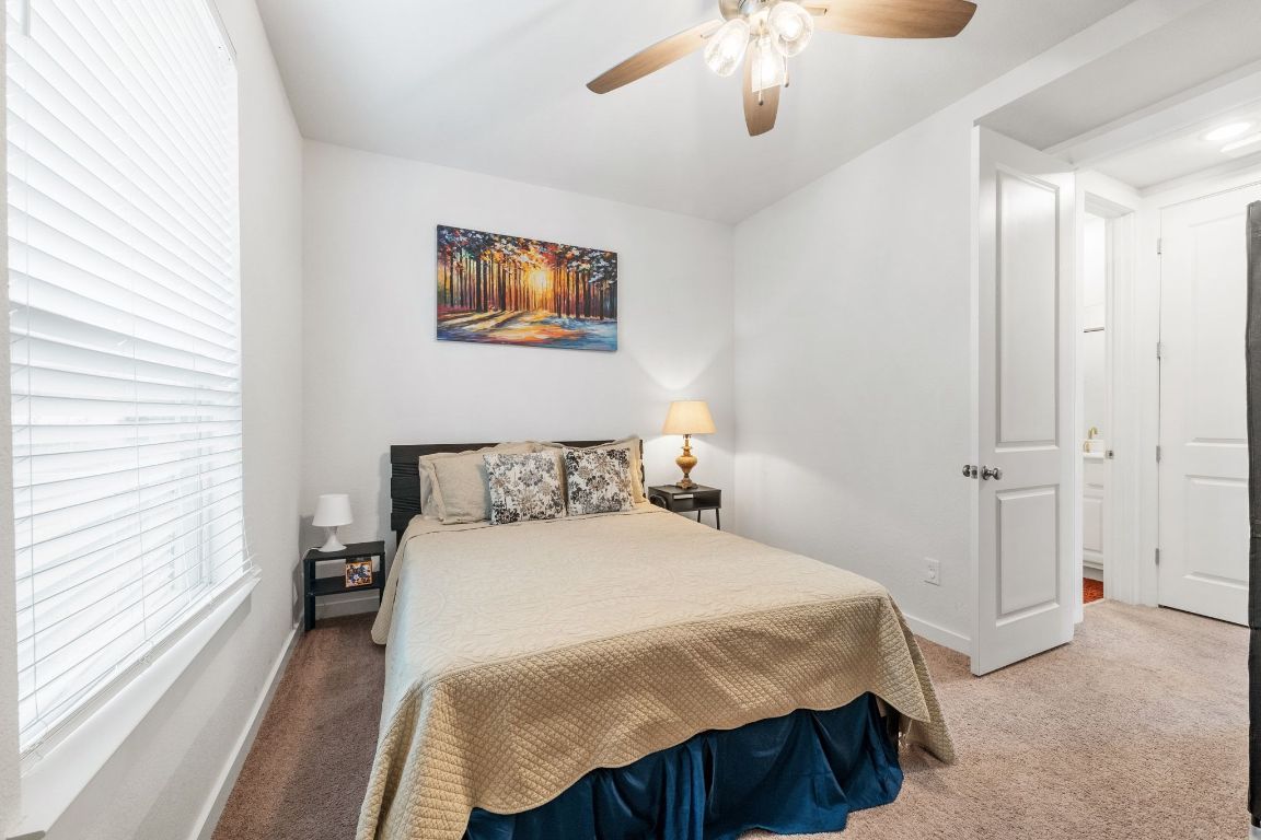 128 Three Oaks Lane Georgetown, TX 78628 - Photo 14 of 40 a bedroom with a bed and a chandelier