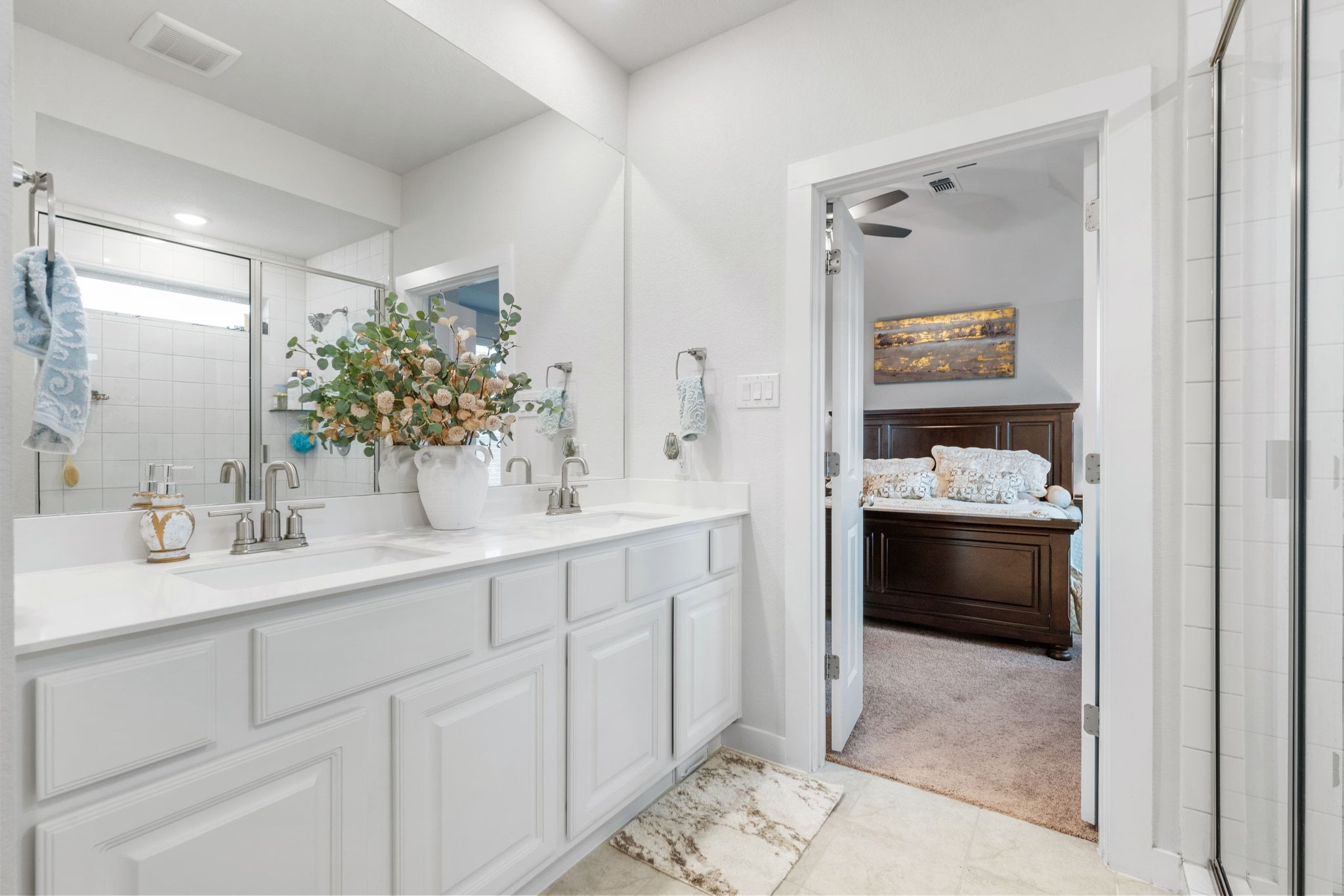 128 Three Oaks Lane Georgetown, TX 78628 - Photo 24 of 40 Ensuite bathroom featuring a stall shower, double vanity, and light carpet