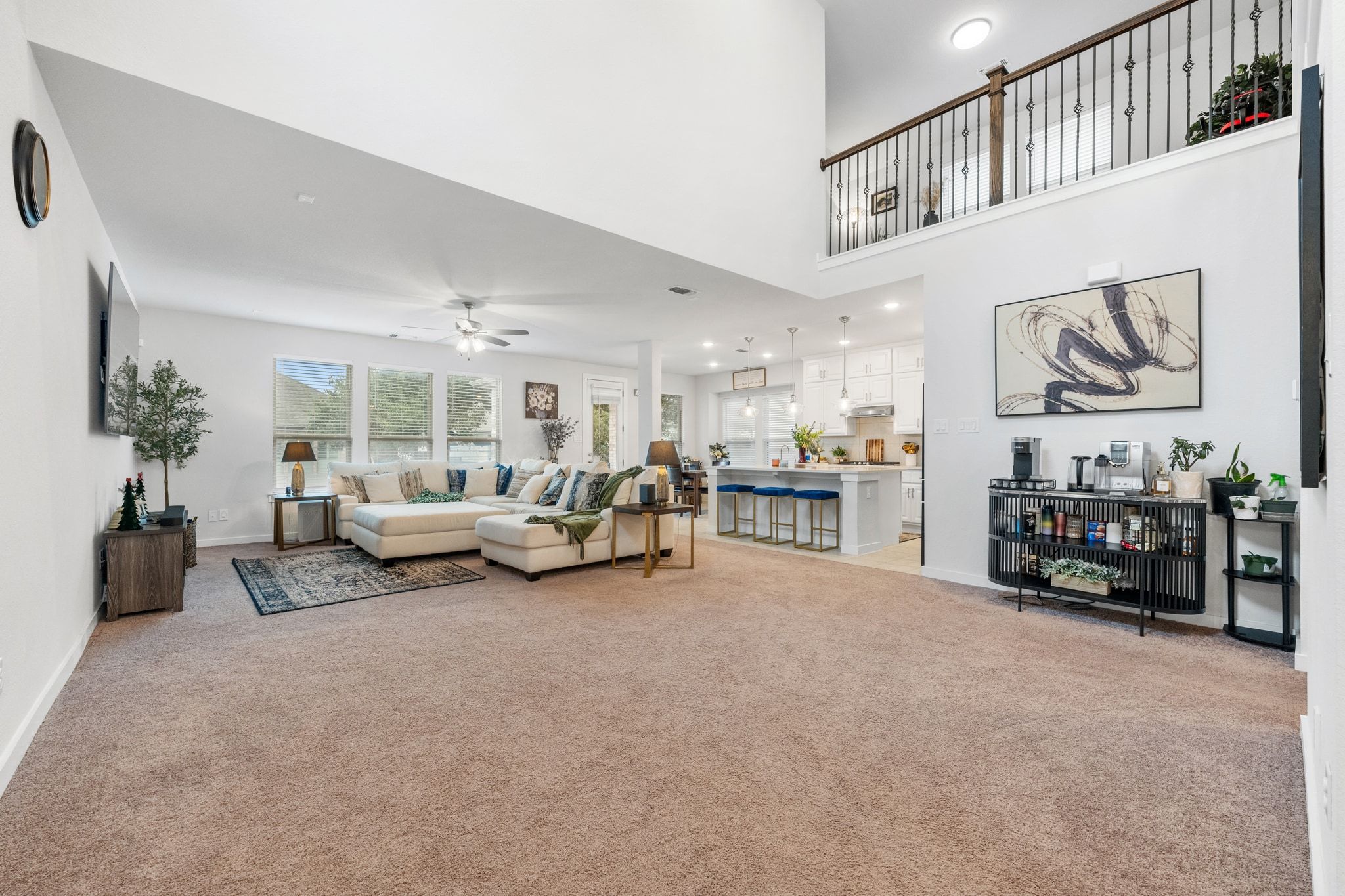 128 Three Oaks Lane Georgetown, TX 78628 - Photo 4 of 40 Living room with light colored carpet, recessed lighting, ceiling fan, and a high ceiling