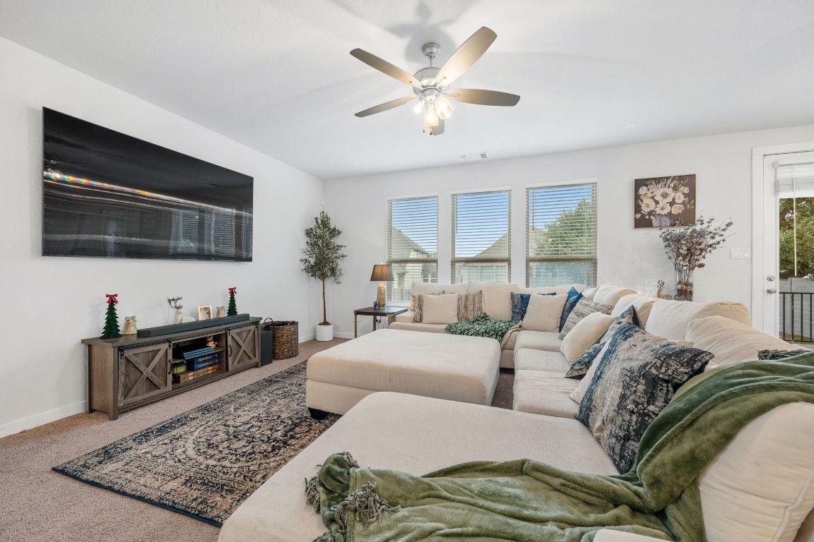 128 Three Oaks Lane Georgetown, TX 78628 - Photo 6 of 40 a living room with furniture ceiling fan and a rug