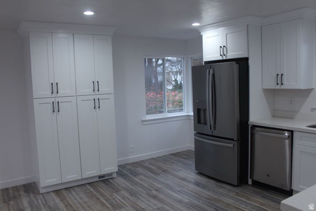 545 100 East Bountiful, UT 84010 - Photo 5 of 17 Kitchen featuring stainless steel appliances, white cabinets, light wood finished floors, recessed lighting, and light stone countertops