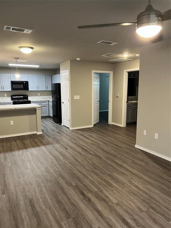 6108 Abrams Road, Unit 215 Dallas, TX 75231 - Photo 14 of 14 a view of kitchen with kitchen island wooden floors and stainless steel appliances