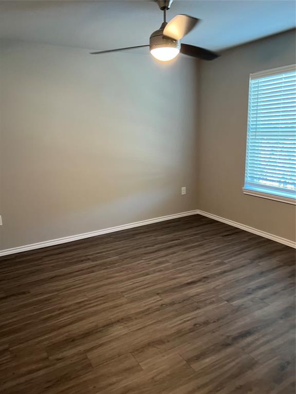 6108 Abrams Road, Unit 215 Dallas, TX 75231 - Photo 4 of 14 a view of an empty room with wooden floor and a window