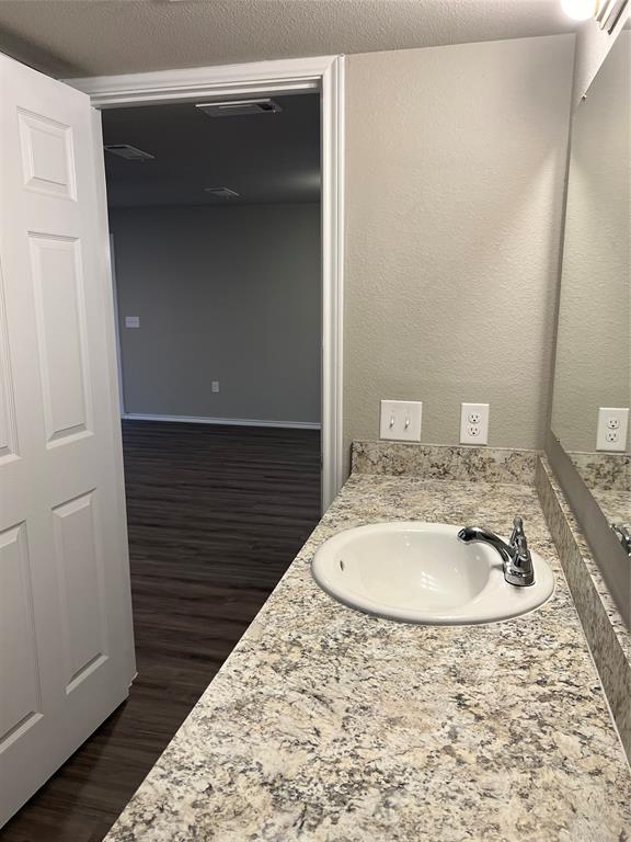 6108 Abrams Road, Unit 215 Dallas, TX 75231 - Photo 10 of 14 a bathroom with a sink and a mirror