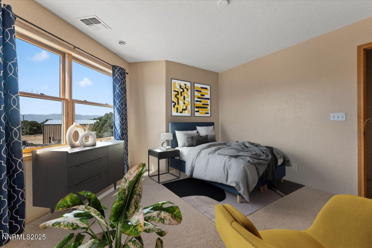 21470 Graves Road Reno, NV 89521 - Photo 14 of 37 a bedroom with a bed lamp and a large window