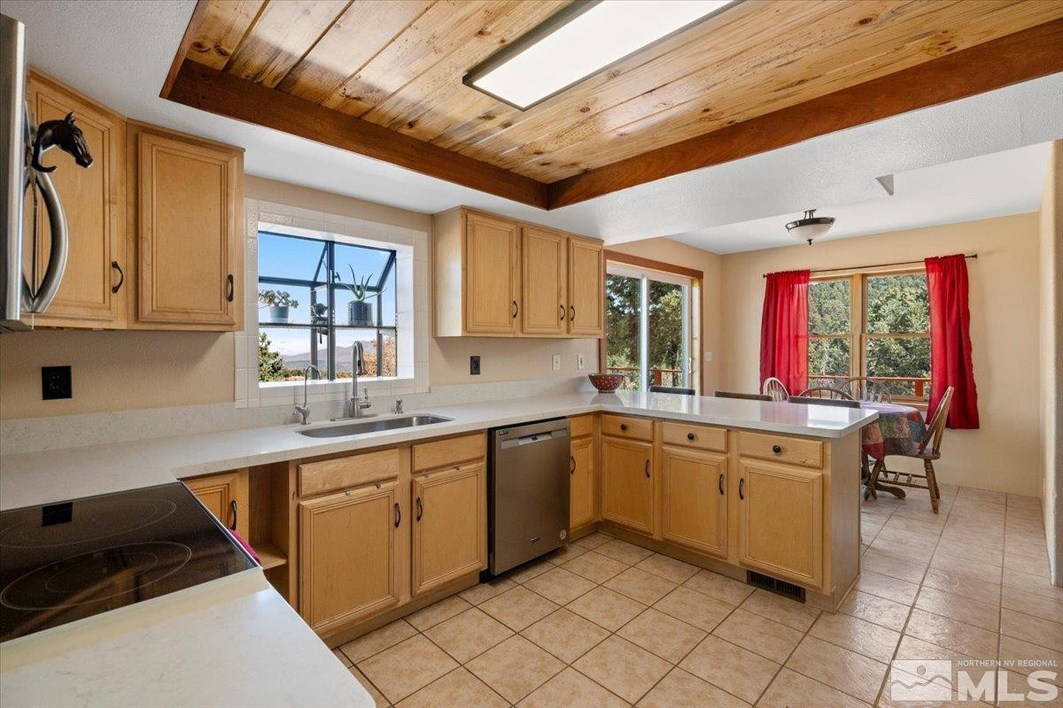 21470 Graves Road Reno, NV 89521 - Photo 5 of 37 a kitchen with a sink window and cabinets