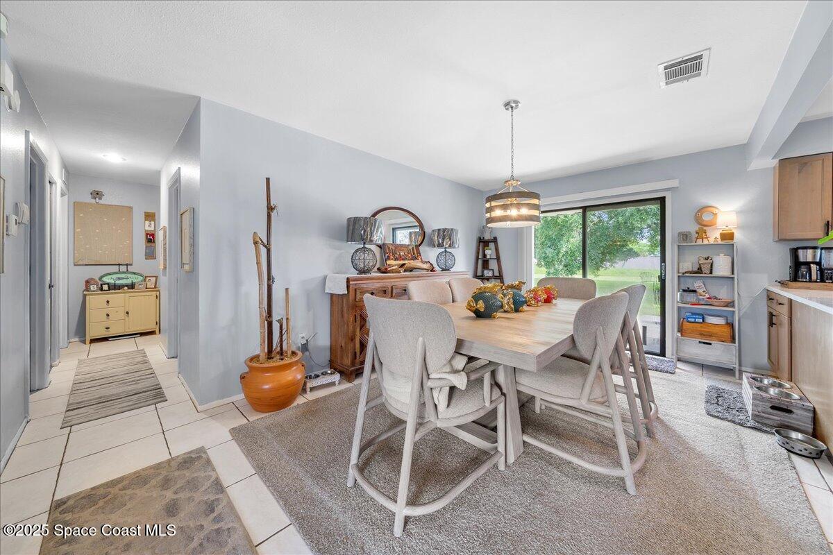 859 Riviera Drive Northeast Palm Bay, FL 32905 - Photo 9 of 26 a view of a dining room with furniture window and outside view