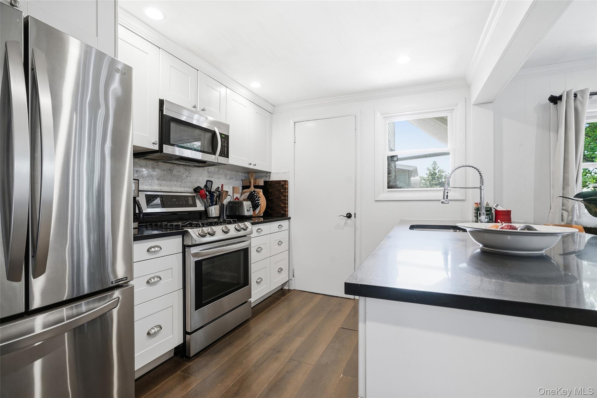 36 Dearborn Avenue Rye, NY 10580 - Photo 11 of 30 a kitchen with stainless steel appliances a sink stove and refrigerator