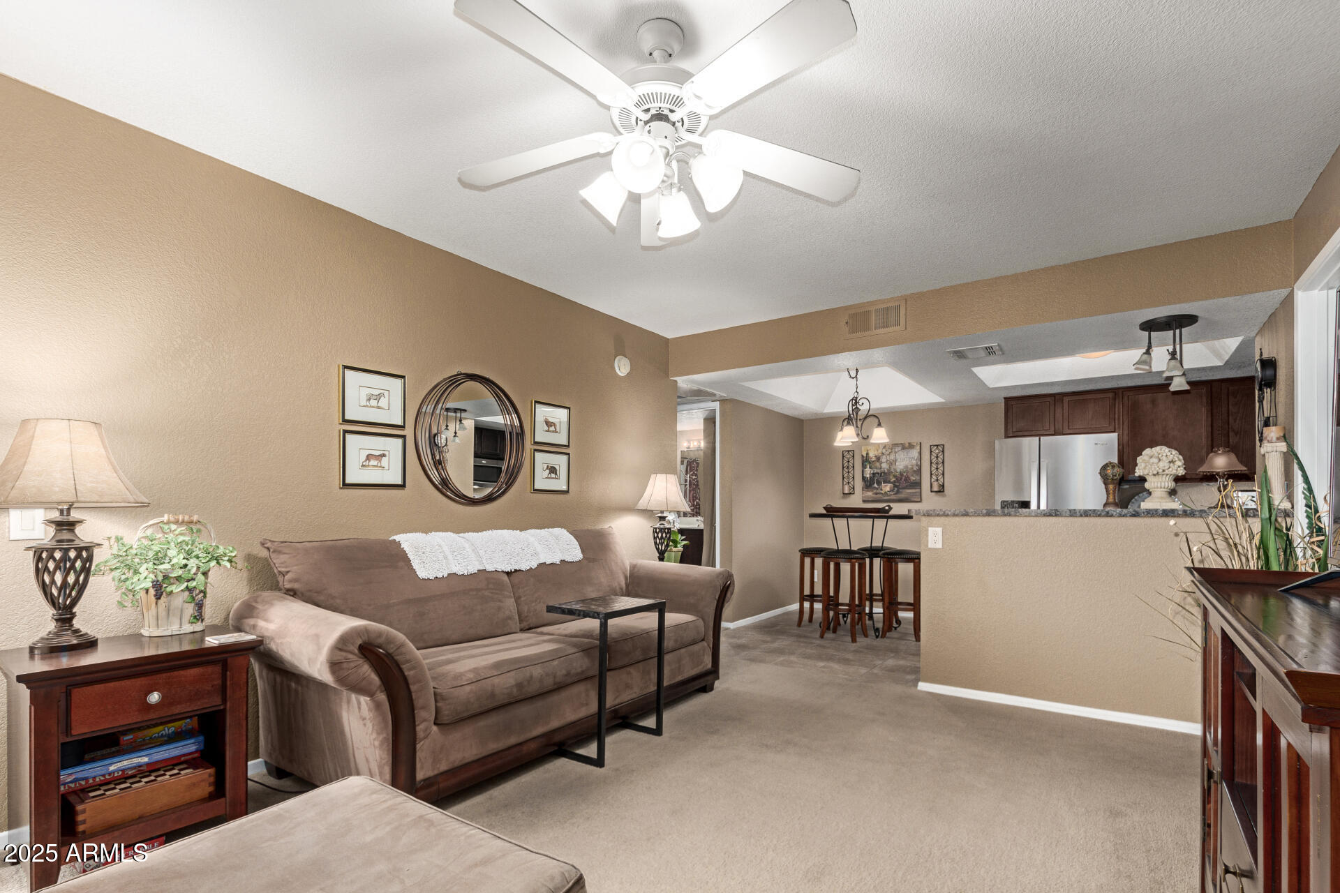 1720 East Thunderbird Road, Unit 2059 Phoenix, AZ 85022 - Photo 3 of 24 a living room with furniture and a chandelier