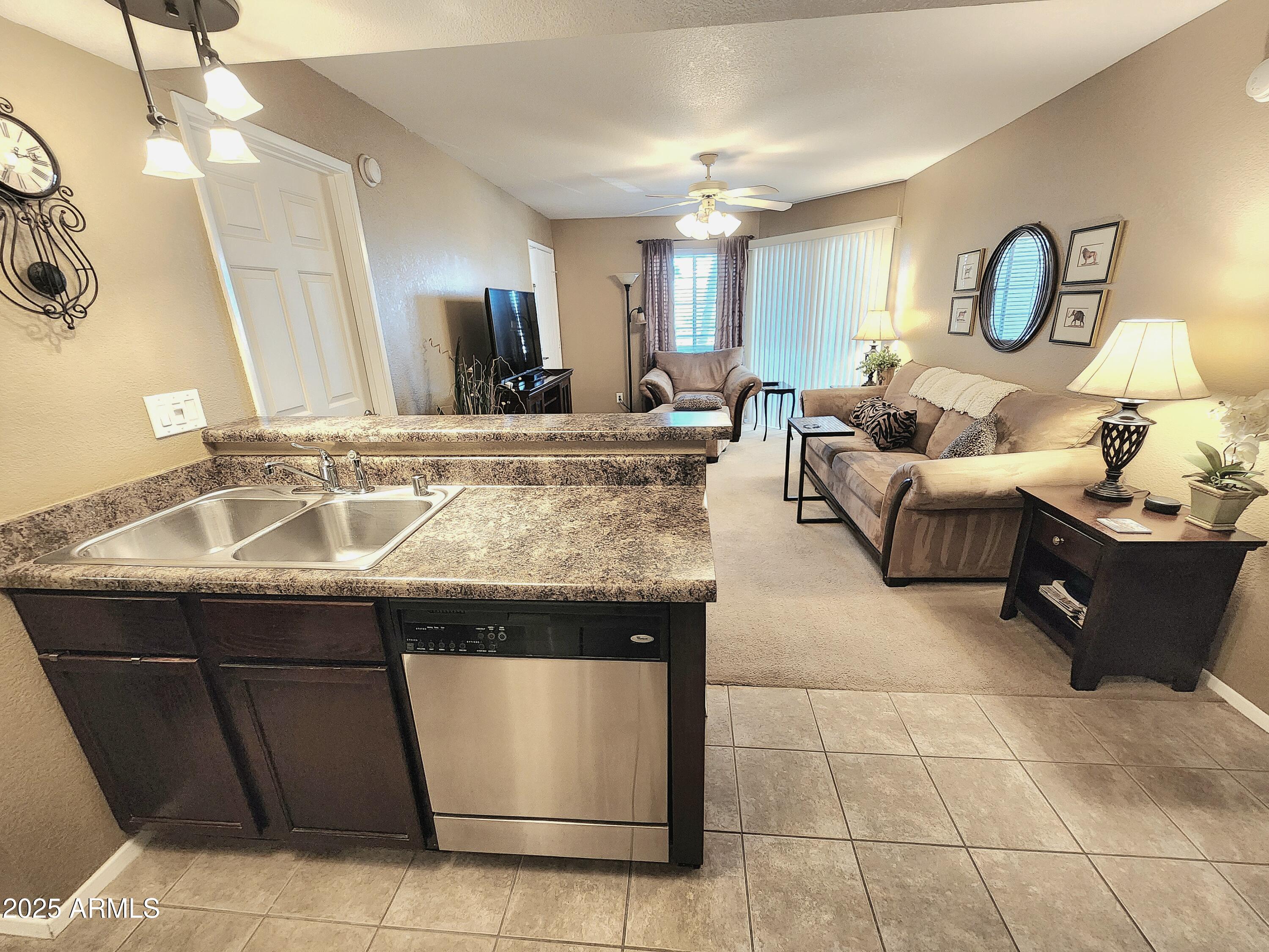 1720 East Thunderbird Road, Unit 2059 Phoenix, AZ 85022 - Photo 6 of 24 a living room with a sink and chandelier
