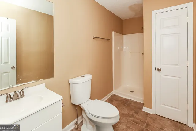 a white toilet sitting next to a bathroom sink