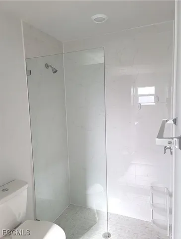 a bathroom with a toilet and a shower