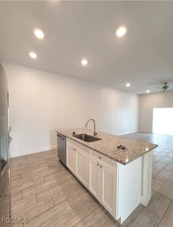 a kitchen with stainless steel appliances granite countertop a sink stove and cabinets