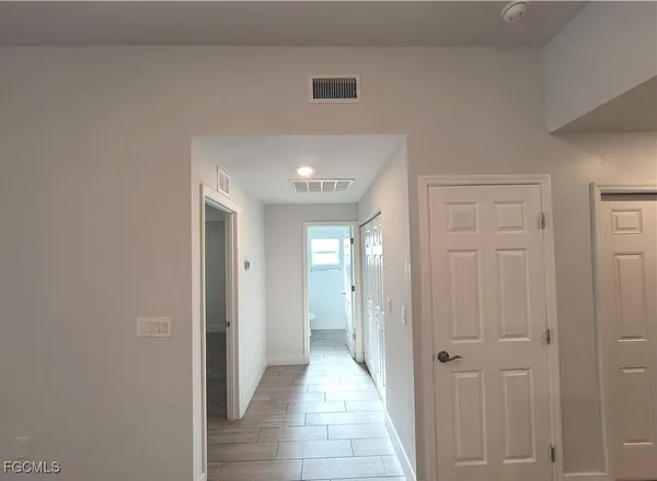 a view of hallway with wooden floor