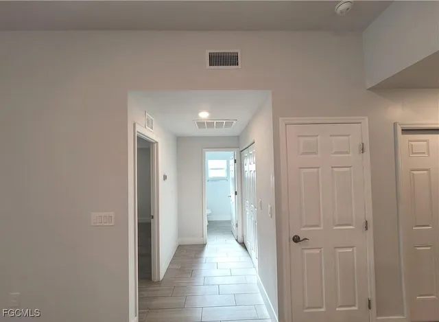 a view of hallway with wooden floor