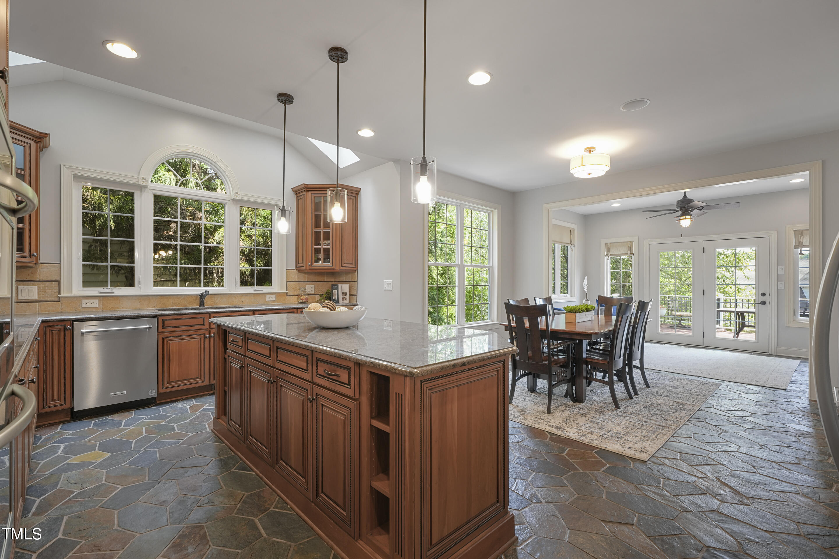 401 South Bend Drive Durham, NC 27713 - Photo 12 of 65 a kitchen with kitchen island granite countertop a table chairs sink and stove top oven