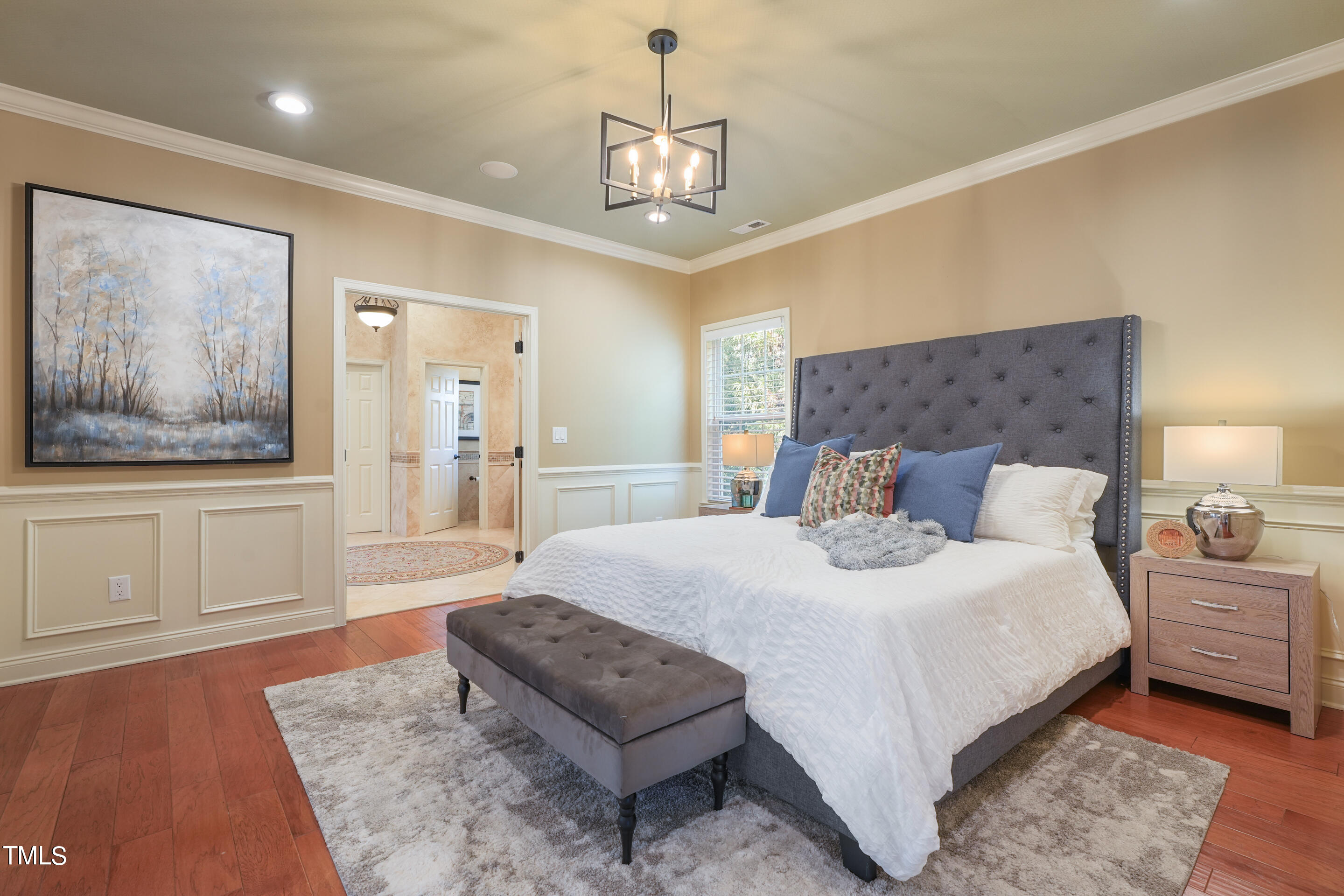 401 South Bend Drive Durham, NC 27713 - Photo 28 of 65 a bedroom with a large bed and a chandelier