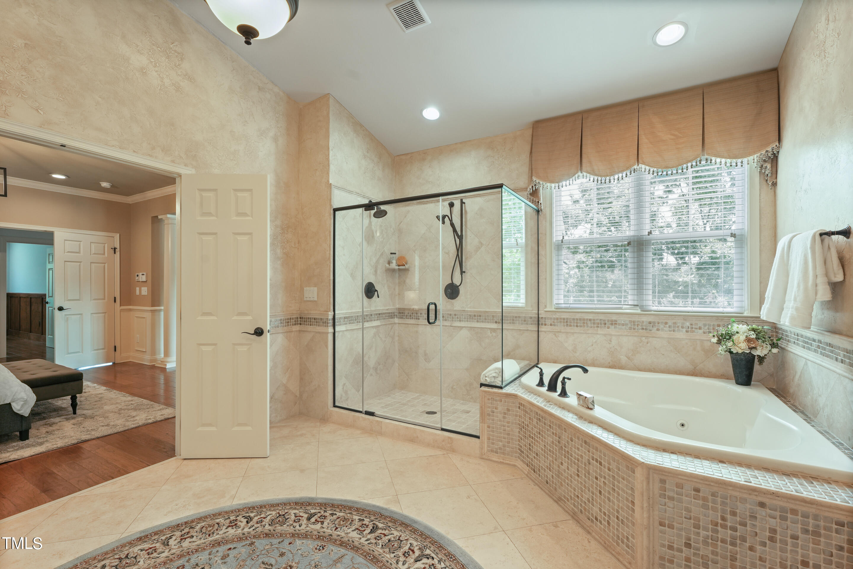 401 South Bend Drive Durham, NC 27713 - Photo 34 of 65 a bathroom with a tub a sink and glass door shower
