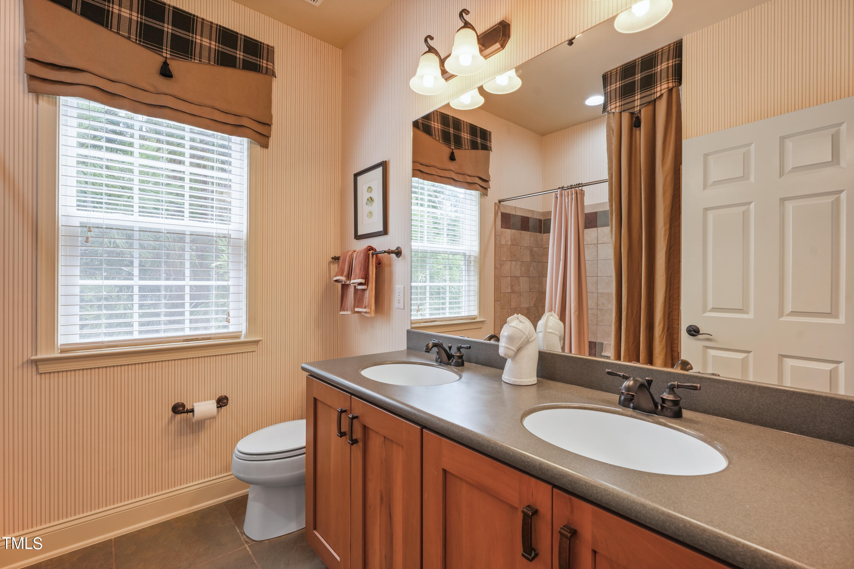 401 South Bend Drive Durham, NC 27713 - Photo 41 of 65 a bathroom with a granite countertop sink a toilet a mirror and a window