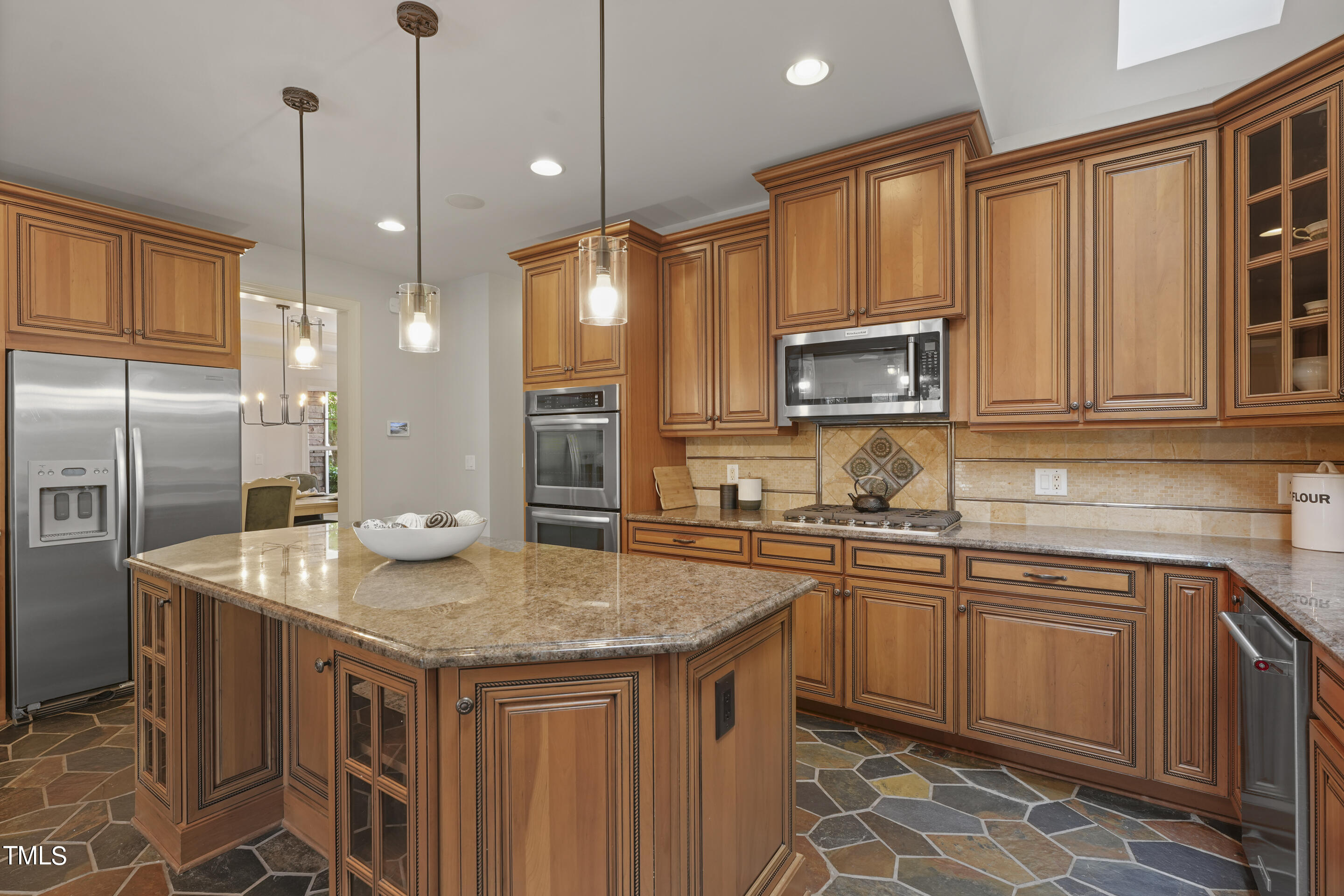 401 South Bend Drive Durham, NC 27713 - Photo 10 of 65 a kitchen with stainless steel appliances granite countertop a sink a stove a refrigerator a center island and cabinets