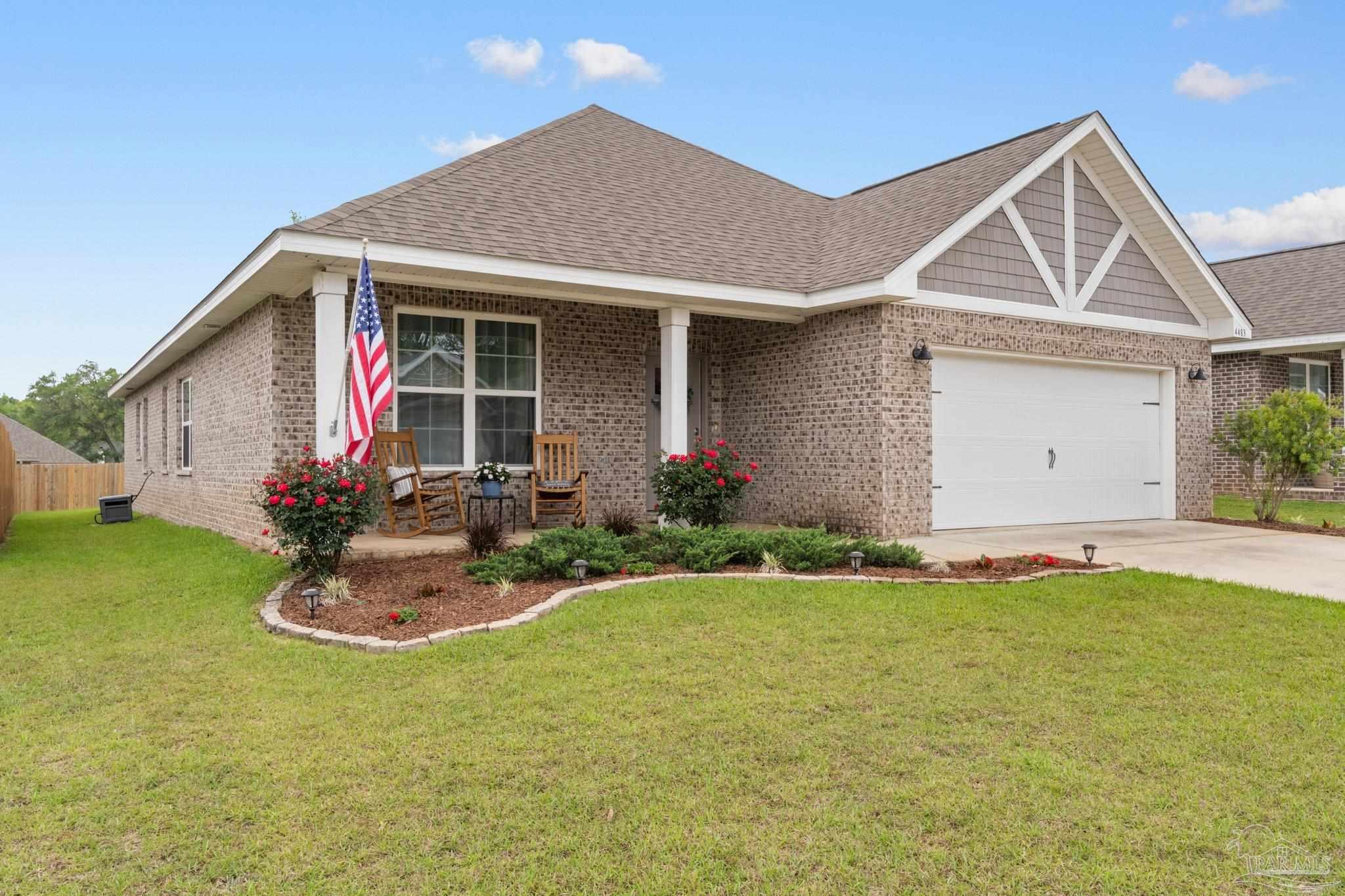 4483 Jude Way Pace, FL 32571 - Photo 1 of 30 a front view of a house with garden