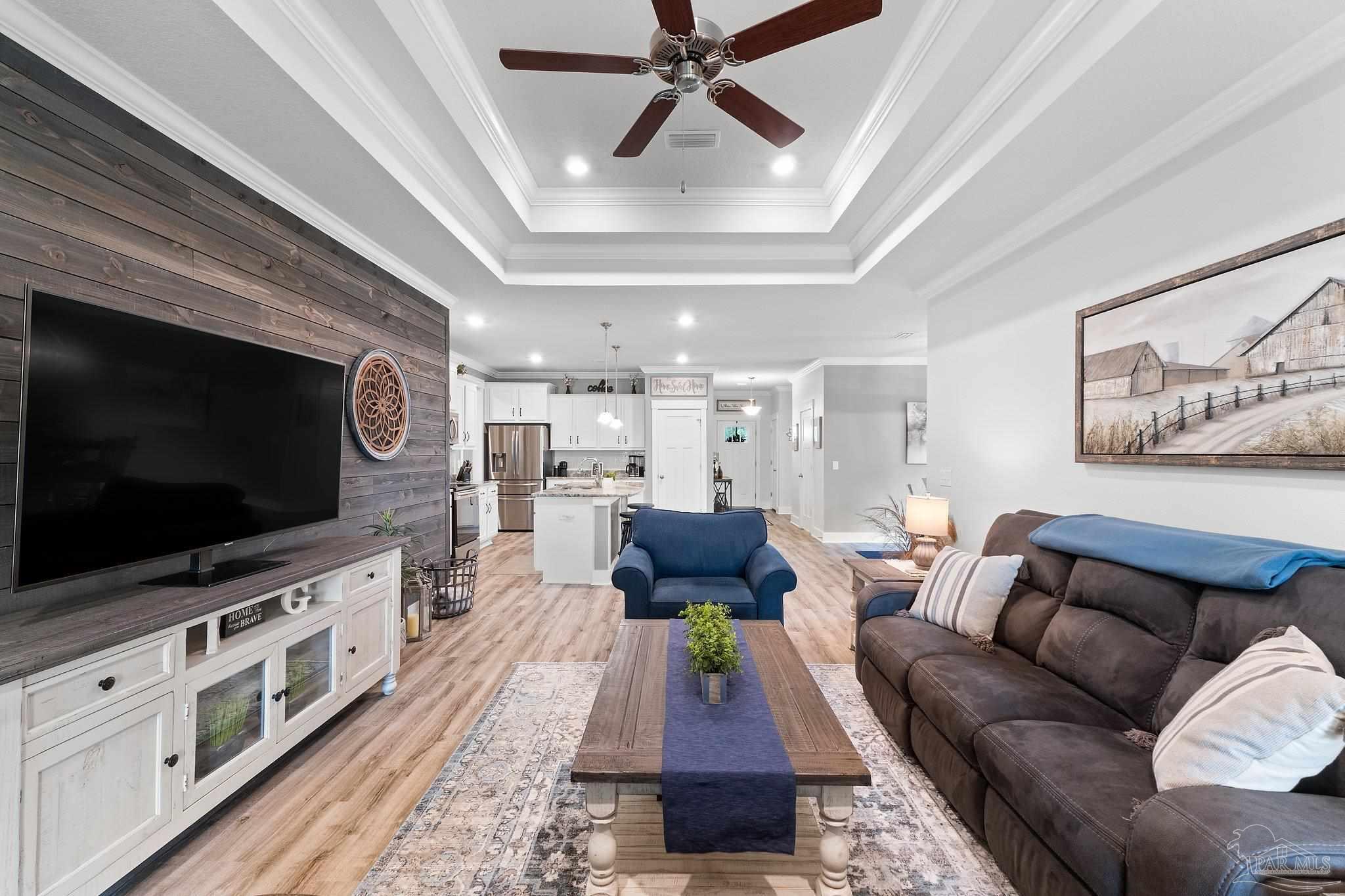 4483 Jude Way Pace, FL 32571 - Photo 12 of 30 a living room with furniture and a flat screen tv
