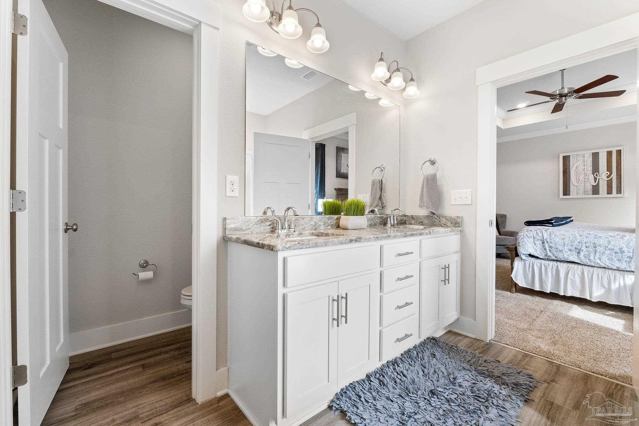 4483 Jude Way Pace, FL 32571 - Photo 15 of 30 a spacious bathroom with a double vanity sink and a mirror