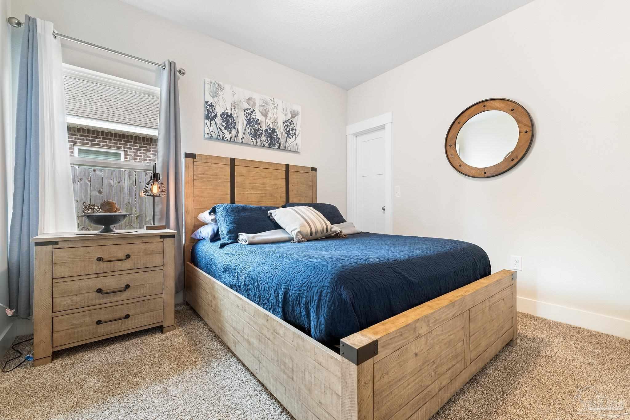 4483 Jude Way Pace, FL 32571 - Photo 17 of 30 a room with a bed and a painting on the wall