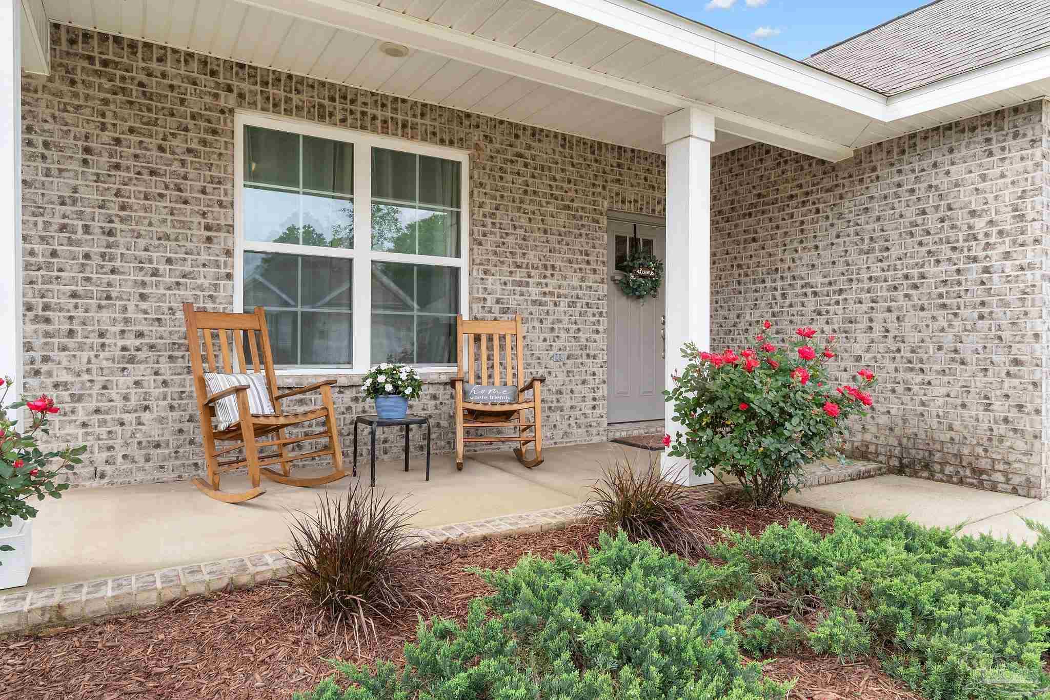4483 Jude Way Pace, FL 32571 - Photo 2 of 30 a view of a patio with table and chairs and potted plants