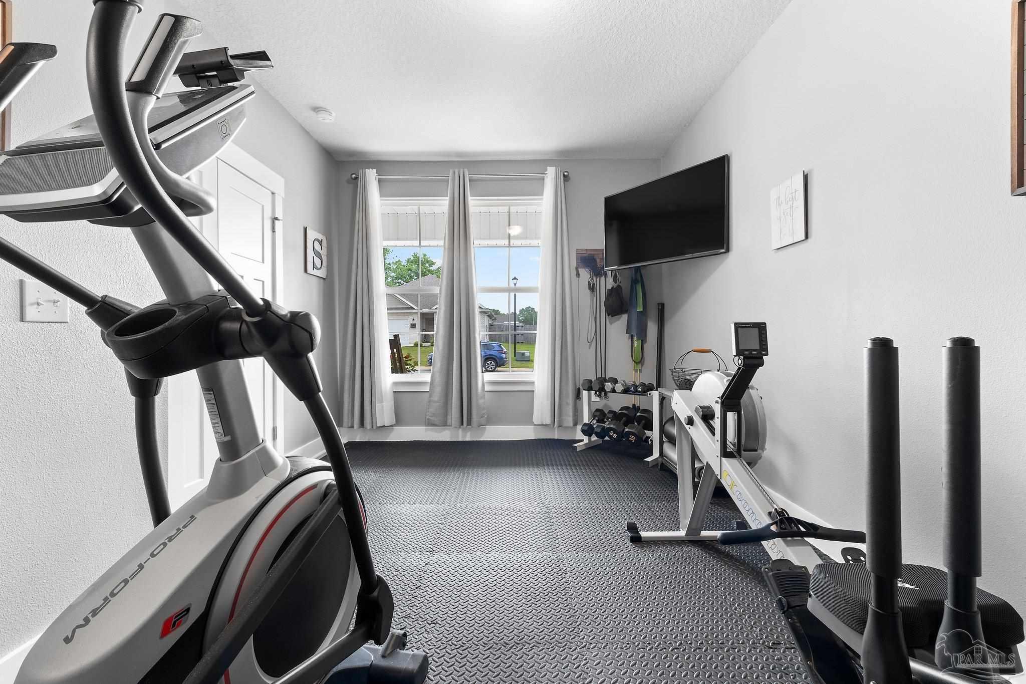 4483 Jude Way Pace, FL 32571 - Photo 23 of 30 a view of a livingroom with furniture and a flat screen tv