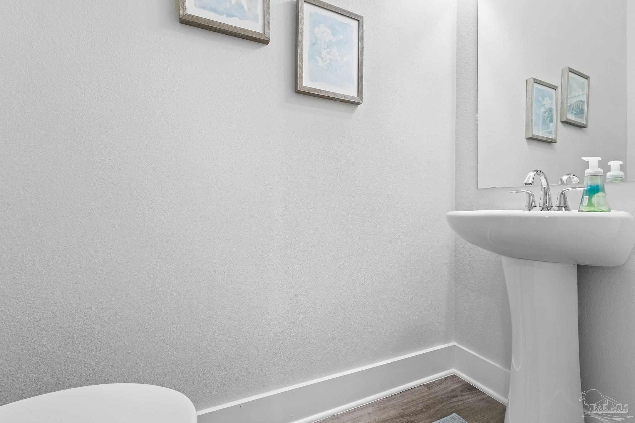 4483 Jude Way Pace, FL 32571 - Photo 24 of 30 a bathroom with a sink and a toilet