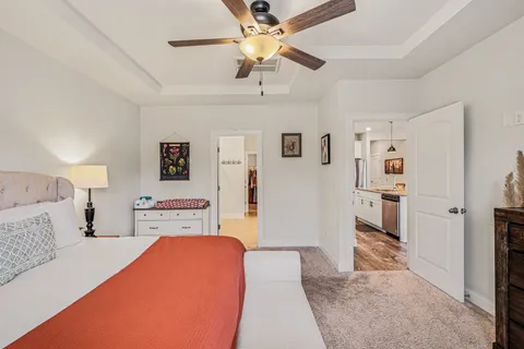 a bedroom with a bed and a chandelier