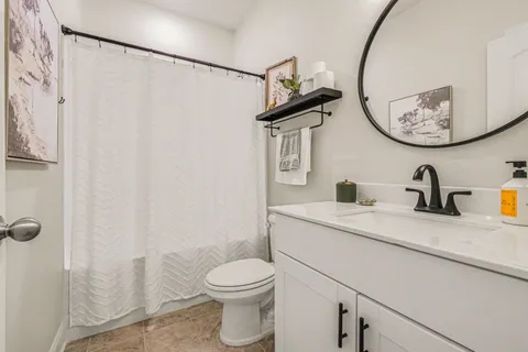 a bathroom with a toilet a sink and a mirror
