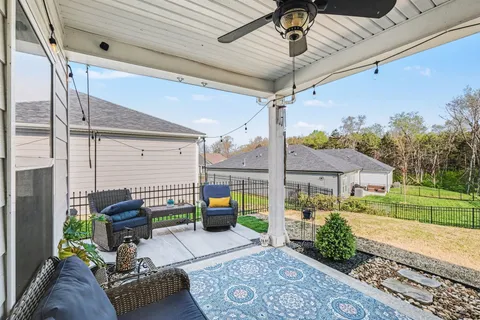 a view of a patio with couches chairs and a potted plant