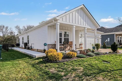a front view of house with yard and outdoor seating