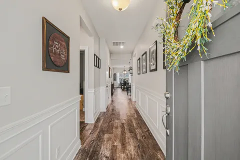 a view of a hallway with wooden floor
