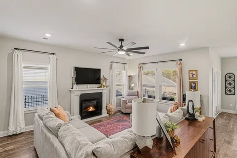 a living room with furniture a flat screen tv and a fireplace