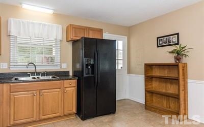 102 Rolling Ridge Circle Garner, NC 27529 - Photo 11 of 23 a kitchen with granite countertop cabinets and refrigerator