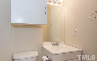 102 Rolling Ridge Circle Garner, NC 27529 - Photo 16 of 23 a bathroom with a toilet a sink and a mirror