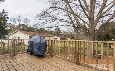 102 Rolling Ridge Circle Garner, NC 27529 - Photo 17 of 23 a view of a deck with wooden floor and fence with a large garden