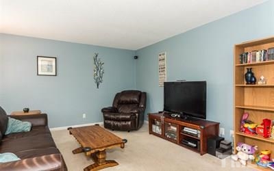 102 Rolling Ridge Circle Garner, NC 27529 - Photo 4 of 23 a living room with furniture and a flat screen tv