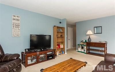 102 Rolling Ridge Circle Garner, NC 27529 - Photo 5 of 23 a living room with furniture and a flat screen tv
