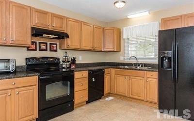 102 Rolling Ridge Circle Garner, NC 27529 - Photo 9 of 23 a kitchen with stainless steel appliances granite countertop a stove a refrigerator and a sink