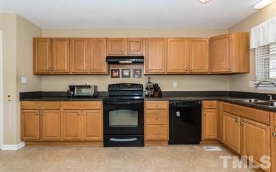 102 Rolling Ridge Circle Garner, NC 27529 - Photo 10 of 23 a kitchen with stainless steel appliances granite countertop a stove a sink and a microwave