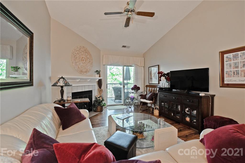 18809 Nautical Drive, Unit 302 Cornelius, NC 28031 - Photo 12 of 22 a living room with furniture a flat screen tv and a fireplace