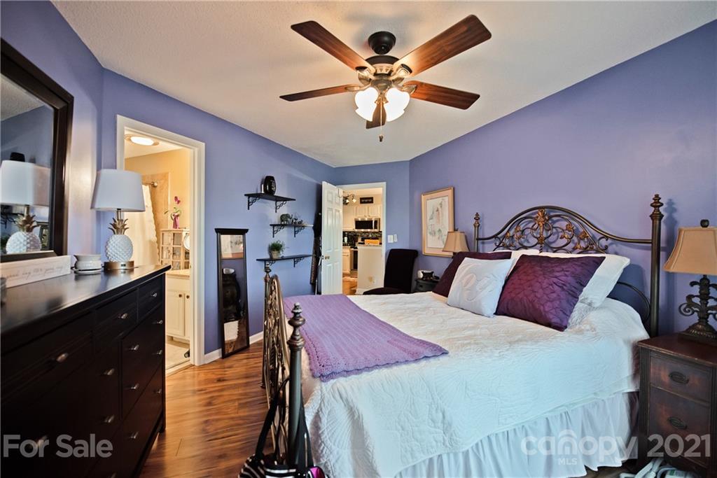 18809 Nautical Drive, Unit 302 Cornelius, NC 28031 - Photo 14 of 22 a bedroom with a bed and a chandelier