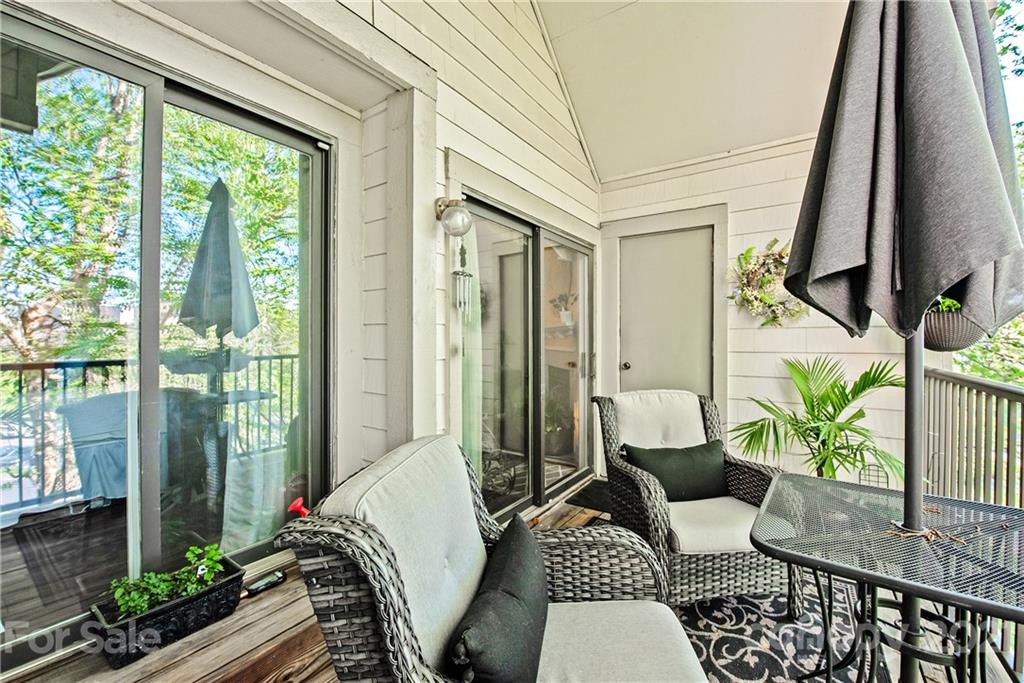 18809 Nautical Drive, Unit 302 Cornelius, NC 28031 - Photo 19 of 22 a living room with furniture and a floor to ceiling window